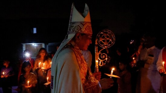 The Diocese of Sindh and Balochistan Church of Pakistan, Bishop Frederick John, leads devotees holding candles on Easter Sunday service, at the Holy Trinity Cathedral Church of Pakistan, in Karachi, Pakistan.(REUTERS)