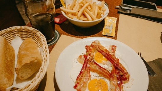 Fake Fried Egg and French Fries: Create a deceptive snack using apple slices, yogurt, and a peach half to mimic fried egg and French fries.&nbsp;(Unsplash)