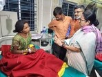 West Bengal Chief Minister Mamata Banerjee meets a cyclone-affected person at the Jalpaiguri Super Specialty Hospital, on Sunday. 