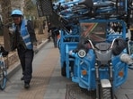 A worker unloads bicycles for a bike-share service in Beijing, China.