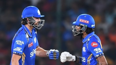 Mumbai Indians' Tim David (L) and captain Hardik Pandya bump their fists during the Indian Premier League (IPL) match (AFP)