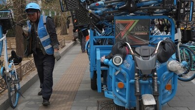 A worker unloads bicycles for a bike-share service in Beijing, China. (AP) A worker unloads bicycles for a bike-share service in Beijing, China. (AP)