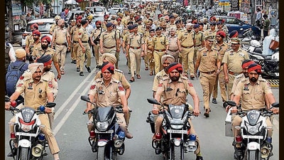 Commissioner of police Kuldeep Singh Chahal with other officials conducted a flag March ahead of Lok Sabha elections in Ludhiana on Monday. (Gurpreet Singh/HT)