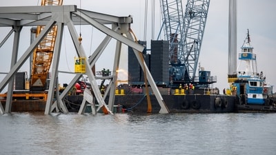 Workers have lifted out the first, 200-ton chunk of Baltimore's collapsed bridge, officials said Sunday, as efforts get underway to clear the harbor of the steel structure destroyed by an out-of-control ship.&nbsp; (REUTERS)