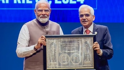 Prime Minister Narendra Modi being presented a memento by RBI Governor Shaktikanta Das during a ceremony marking 90 years of the Reserve Bank of India, in Mumbai. (PTI)