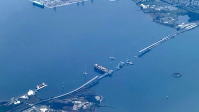 This aerial view shows the collapsed Francis Scott Key Bridge lying on top of the container ship Dali in Baltimore, Maryland, as clean-up work begins. (AFP) This aerial view shows the collapsed Francis Scott Key Bridge lying on top of the container ship Dali in Baltimore, Maryland, as clean-up work begins. (AFP)