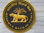 RBI Monetary Policy Committee Meeting: A security official walks past an emblem of the Reserve Bank of India at the RBI headquarters, in Mumbai.
