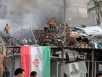 Emergency and security personnel extinguish a fire at the site of strikes which hit a building annexed to the Iranian embassy in Syria's capital Damascus, on April 1, 2024.