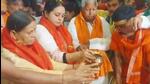 Rohini Acharya (middle) along with her father Lalu Prasad Yadav (right) and mother Rabri Devi (left) offers prayers at the Baba Hariharnath temple. (Image potsed by Rohini Acharya on X.)