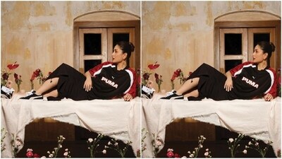 For one of the looks, Kareena wore a black Puma T-shirt with a trendy red print on the sleeves and white stripes. She paired it with a black knee-length skirt giving off cool girl vibes. (Instagram/@kareenakapoorkhan) For one of the looks, Kareena wore a black Puma T-shirt with a trendy red print on the sleeves and white stripes. She paired it with a black knee-length skirt giving off cool girl vibes. (Instagram/@kareenakapoorkhan)