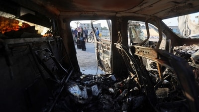 Palestinians look at a vehicle where employees from the World Central Kitchen (WCK), including foreigners, were killed in an Israeli airstrike. (Reuters)