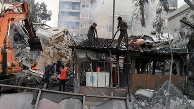 In this photo released by the official Syrian state news agency SANA, emergency service workers clear the rubble at a destroyed building struck by Israeli jets in Damascus, Syria. (SANA via AP) In this photo released by the official Syrian state news agency SANA, emergency service workers clear the rubble at a destroyed building struck by Israeli jets in Damascus, Syria. (SANA via AP)
