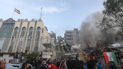 Emergency and security personnel search the rubble at the site of strikes which hit a building annexed to the Iranian embassy in Syria's capital Damascus, on April 1, 2024. (AFP)