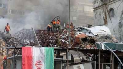 Emergency and security personnel extinguish a fire at the site of strikes which hit a building annexed to the Iranian embassy in Syria's capital Damascus, on April 1, 2024. (AFP)