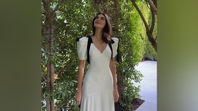 While Kendall added the coquette aesthetic to her look with the feminine silhouette of her midi-length dress, the bow trend is incorporated with the black velvet bow embellishments adorned on the shoulder pads of the ensemble. (Instagram) While Kendall added the coquette aesthetic to her look with the feminine silhouette of her midi-length dress, the bow trend is incorporated with the black velvet bow embellishments adorned on the shoulder pads of the ensemble. (Instagram)