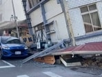 A woman stands near a partially collapsed building in Hualien, eastern Taiwan on Wednesday. A woman stands near a partially collapsed building in Hualien, eastern Taiwan on Wednesday.