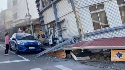 A woman stands near a partially collapsed building in Hualien, eastern Taiwan on Wednesday. (AP) A woman stands near a partially collapsed building in Hualien, eastern Taiwan on Wednesday. (AP)