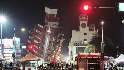 Emergency personnel stand in front of a partially collapsed building leaning over a street in Hualien, after a major earthquake hit Taiwan's east, on Wednesday. (AFP) Emergency personnel stand in front of a partially collapsed building leaning over a street in Hualien, after a major earthquake hit Taiwan's east, on Wednesday. (AFP)