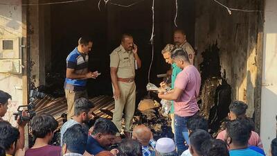 Police personnel and locals at the site after a fire broke out at a tailoring shop, in Chhatrapati Sambhajinagar, Wednesday. (PTI)
