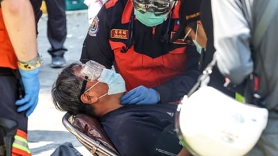 This photo taken by Taiwan's Central News Agency (CNA) on April 3, 2024, shows emergency workers attending to a survivor, who had been trapped in a damaged building, in New Taipei City, after a major earthquake hit Taiwan's east. (AFP) This photo taken by Taiwan's Central News Agency (CNA) on April 3, 2024, shows emergency workers attending to a survivor, who had been trapped in a damaged building, in New Taipei City, after a major earthquake hit Taiwan's east. (AFP)