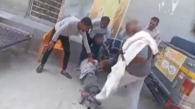Screenshot from the viral video of Bittu Banjrangi thrashing a man with a stick in front of his residence.