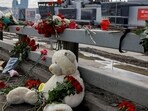 FILE PHOTO: Flowers and toys are placed on the roadside in front of the burnt-out Crocus City Hall following a deadly attack on the concert venue on the outskirts of Moscow, Russia, March 26, 2024. REUTERS/Evgenia Novozhenina/File Photo