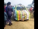 The image shows the car decorated with chips packets. 