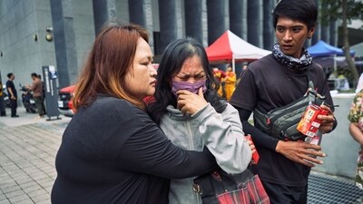 A woman is reunited with her family after being rescued from the Silks Place Taroko Hotel following the earthquake in Hualien, Taiwan. (Bloomberg) A woman is reunited with her family after being rescued from the Silks Place Taroko Hotel following the earthquake in Hualien, Taiwan. (Bloomberg)