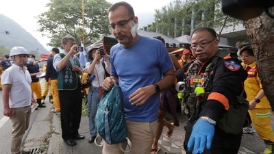 A trapped tourist of Taroko National Park walks to an ambulance after being rescued in Hualien County, eastern Taiwan, Thursday. (AP) A trapped tourist of Taroko National Park walks to an ambulance after being rescued in Hualien County, eastern Taiwan, Thursday. (AP)