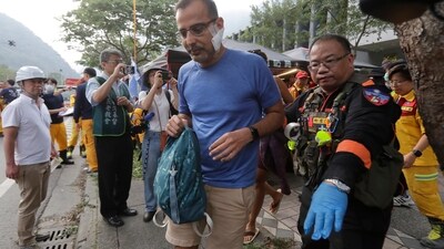 A trapped tourist of Taroko National Park walks to an ambulance after being rescued in Hualien County, eastern Taiwan. (AP) A trapped tourist of Taroko National Park walks to an ambulance after being rescued in Hualien County, eastern Taiwan. (AP)