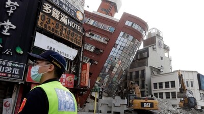 A police officer stands guard near a partially collapsed building a day after a powerful earthquake struck in Hualien City, eastern Taiwan, Thursday, April 4, 2024. (AP Photo/Chiang Ying-ying) (AP) A police officer stands guard near a partially collapsed building a day after a powerful earthquake struck in Hualien City, eastern Taiwan, Thursday, April 4, 2024. (AP Photo/Chiang Ying-ying) (AP)