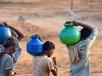 Chikkamagaluru: Residents carry pots after collecting drinking water amidst ongoing water crisis, in Chikkamagaluru, on Friday. (PTI) Chikkamagaluru: Residents carry pots after collecting drinking water amidst ongoing water crisis, in Chikkamagaluru, on Friday. (PTI)