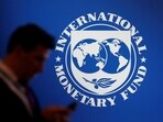 &nbsp;A participant stands near a logo of IMF at the International Monetary Fund - World Bank annual meeting &nbsp;in Nusa Dua, Bali, Indonesia.