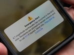 A person shows an emergency alert on a phone after an earthquake shook New York City, U.S., April 5, 2024. REUTERS/Adam Gray