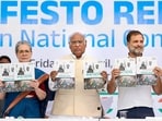 Congress President Mallikarjun Kharge with senior party leaders Sonia Gandhi and Rahul Gandhi releases the party's manifesto ahead of Lok Sabha elections, in New Delhi, Friday, April 5, 2024.(PTI)