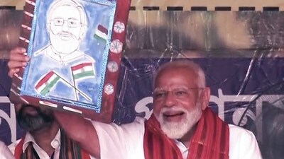 PM Narendra Modi carries a portrait of himself during a public rally ahead of the Lok Sabha elections, in Cooch Behar. (ANI) PM Narendra Modi carries a portrait of himself during a public rally ahead of the Lok Sabha elections, in Cooch Behar. (ANI)
