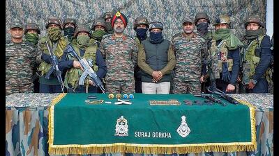 Army personnel display arms and ammunition recovered after security forces foiled an infiltration bid along the Line of Control, in Uri on Friday. (HT Photo) Army personnel display arms and ammunition recovered after security forces foiled an infiltration bid along the Line of Control, in Uri on Friday. (HT Photo)