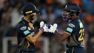 Gujarat Titans' captain Shubman Gill (L) and Sai Sudharsan bump their fists. (AFP)