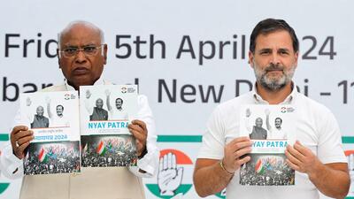 Congress leaders Mallikarjun Kharge and Rahul Gandhi display the party's manifesto for the general election in New Delhi (REUTERS)