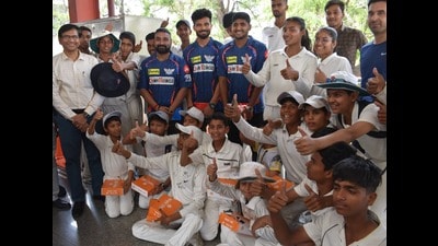 Cricket trainees of the KD Singh Babu Stadium with LSG members, in Lucknow, on Friday. (HT Photo)