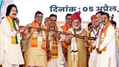 Prime Minister Narendra Modi being presented a memento during a public meeting ahead of Lok Sabha elections, in Churu (PTI) Prime Minister Narendra Modi being presented a memento during a public meeting ahead of Lok Sabha elections, in Churu (PTI)