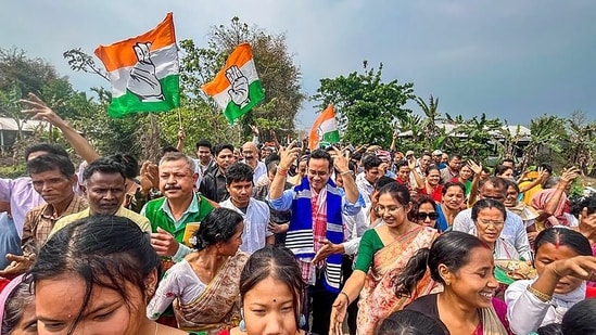 Congress candidate from Jorhat constituency, Gaurav Gogoi, dances with supporters during a campaign in Majuli, Assam.(PTI)