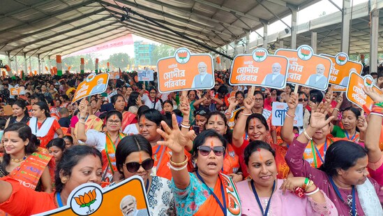 BJP supporters cheer during an election campaign rally addressed by PM Narendra Modi ahead of the upcoming Lok Sabha polls, in Cooch Behar district.(PTI)