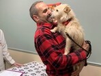 Mehrad Houman holds his dog, Mishka, after she was examined by the veterinarian. Mehrad Houman holds his dog, Mishka, after she was examined by the veterinarian.