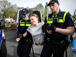 Police detain Swedish climate activist Greta Thunberg (C) during a climate march against fossil subsidies near the highway A12 in the Hague, on April 6, 2024. 