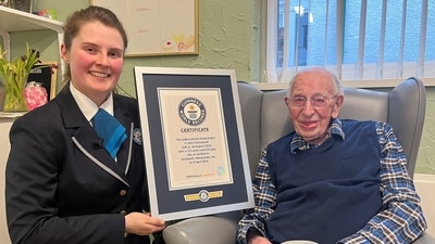 John Tinniswood, 111, poses with his certificate from the Guinness World Records, who announced that he is the world's oldest living man, in Southport, Britain April 4, 2024 in this handout image. Guinness World Records/Handout via REUTERS