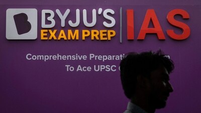 A man walks past an advertising hoarding of Byju's, an Education Technology company and one of India's biggest startup, outside one of its branches in New Delhi (REUTERS