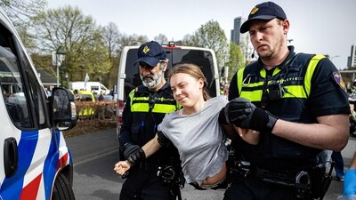 Police detain Swedish climate activist Greta Thunberg (C) during a climate march against fossil subsidies near the highway A12 in the Hague, on April 6, 2024. (AFP)