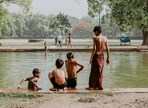 Kids try to beat the summer heat by taking a much needed dip in a pond 