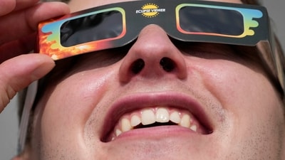 A man wears special glasses to watch the partial solar eclipse in Trafalgar Square, London, on June 10. The eclipse was expected to be partial, which means the people in its shadow weren't plunged into daytime darkness. (Frank Augstein / AP) A man wears special glasses to watch the partial solar eclipse in Trafalgar Square, London, on June 10. The eclipse was expected to be partial, which means the people in its shadow weren't plunged into daytime darkness. (Frank Augstein / AP)